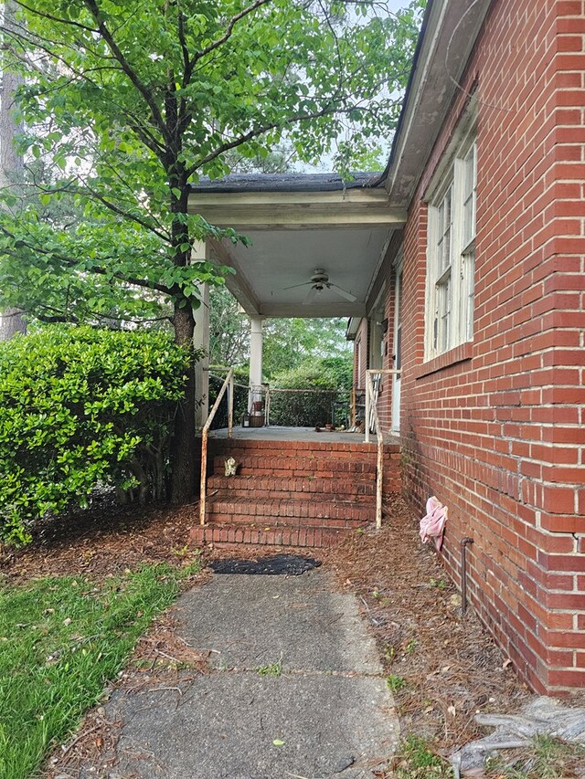 view of yard with a porch and ceiling fan
