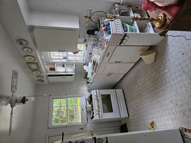kitchen featuring white microwave and wallpapered walls