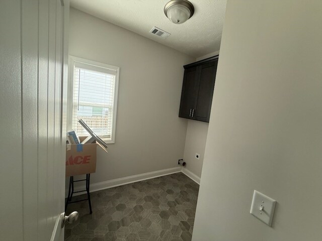 7300 Pine Chase Dr, Midland, GA 31820 - washroom with cabinet space, hookup for an electric dryer, and a textured ceiling