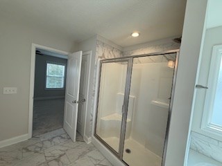 7300 Pine Chase Dr, Midland, GA 31820 - bathroom featuring marble look tiles, a stall shower, a tub, and recessed lighting