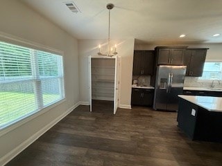 7300 Pine Chase Dr, Midland, GA 31820 - kitchen featuring stainless steel refrigerator with ice dispenser, light countertops, dark wood-style floors, hanging light fixtures, and a chandelier