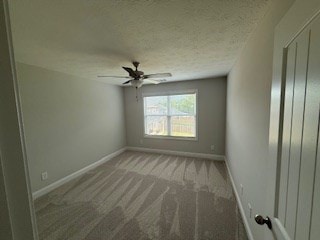 7300 Pine Chase Dr, Midland, GA 31820 - carpeted empty room with ceiling fan and a textured ceiling