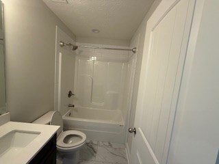 7300 Pine Chase Dr, Midland, GA 31820 - bathroom with marble look tile flooring, vanity, bathing tub / shower combination, and a textured ceiling