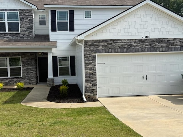 7300 Pine Chase Dr, Midland, GA 31820 - craftsman-style home with stone siding, concrete driveway, a garage, and a front yard