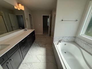 7300 Pine Chase Dr, Midland, GA 31820 - bathroom with double vanity, a garden tub, and marble finish floors