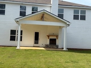 7300 Pine Chase Dr, Midland, GA 31820 - back of house with a lawn, a chimney, and a patio area
