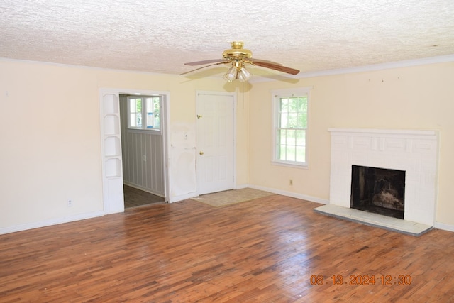 unfurnished living room featuring dark hardwood / wood-style floors, ceiling fan, and a wealth of natural light