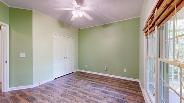 4756 Timarron Loop, Columbus, GA 31909 - unfurnished bedroom featuring crown molding, wood finished floors, multiple windows, a textured ceiling, and a closet