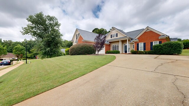 4756 Timarron Loop, Columbus, GA 31909 - view of front facade featuring brick siding, curved driveway, and a front yard
