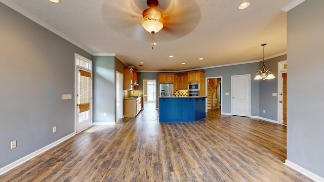 4756 Timarron Loop, Columbus, GA 31909 - kitchen with appliances with stainless steel finishes, open floor plan, recessed lighting, brown cabinetry, and a chandelier
