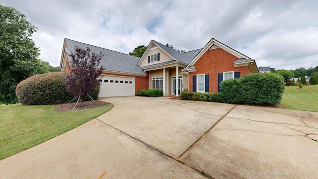 4756 Timarron Loop, Columbus, GA 31909 - view of front of home featuring brick siding, driveway, a garage, and a front yard