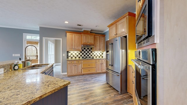 4756 Timarron Loop, Columbus, GA 31909 - kitchen with appliances with stainless steel finishes, crown molding, backsplash, light wood-style flooring, and light stone counters