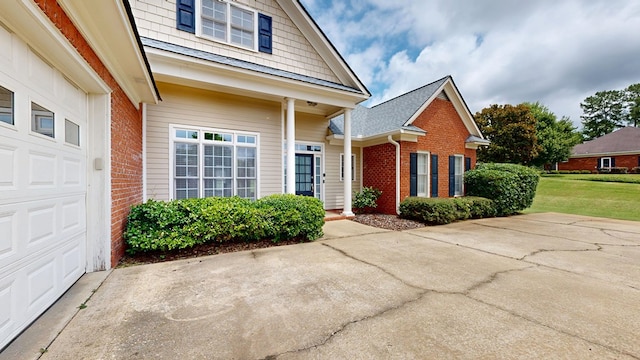 4756 Timarron Loop, Columbus, GA 31909 - view of exterior entry with brick siding, concrete driveway, and an attached garage
