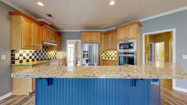 4756 Timarron Loop, Columbus, GA 31909 - kitchen with stainless steel appliances, dark wood-type flooring, tasteful backsplash, recessed lighting, and a breakfast bar area