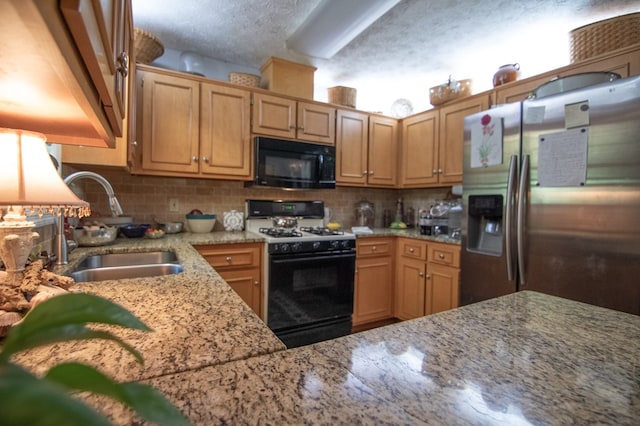 5063 3rd Ave, Columbus, GA 31904 - kitchen with black microwave, stainless steel refrigerator with ice dispenser, gas range oven, and decorative backsplash