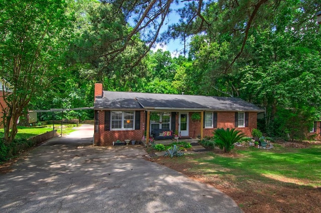 5063 3rd Ave, Columbus, GA 31904 - ranch-style house featuring driveway, a chimney, brick siding, a carport, and a front yard