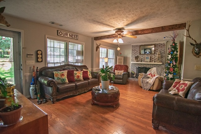 5063 3rd Ave, Columbus, GA 31904 - living area with a textured ceiling, ceiling fan, wood finished floors, and a brick fireplace
