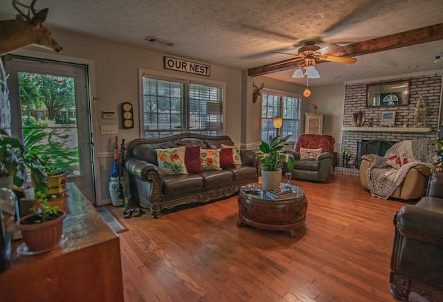 5063 3rd Ave, Columbus, GA 31904 - living area featuring a textured ceiling, wood finished floors, ceiling fan, and a fireplace