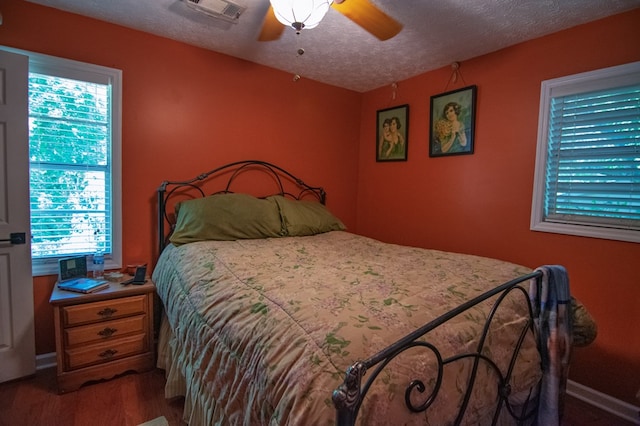5063 3rd Ave, Columbus, GA 31904 - bedroom featuring multiple windows, wood finished floors, a textured ceiling, and a ceiling fan