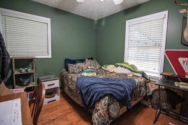 5063 3rd Ave, Columbus, GA 31904 - bedroom featuring wood finished floors, a textured ceiling, and a ceiling fan