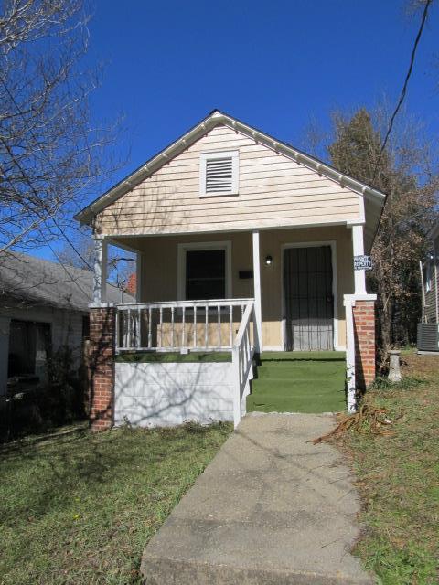 view of front of house with a porch, central AC unit, and a front yard