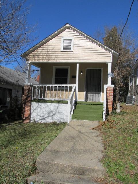 bungalow-style home with a front yard, central air condition unit, and covered porch