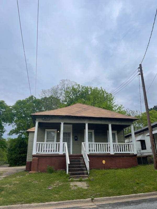 bungalow with a porch and a front yard