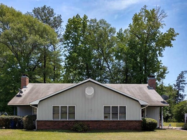 6200 Olde Towne Dr, Columbus, GA 31907 - view of home's exterior with a chimney, brick siding, and a lawn