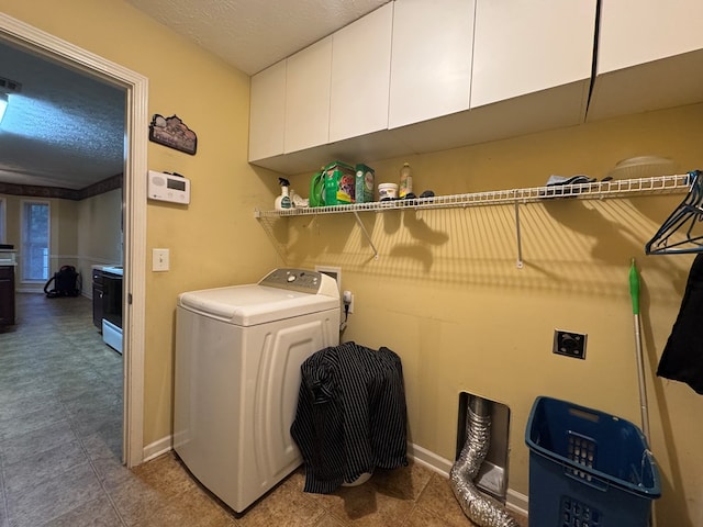 clothes washing area with cabinets and washer / dryer