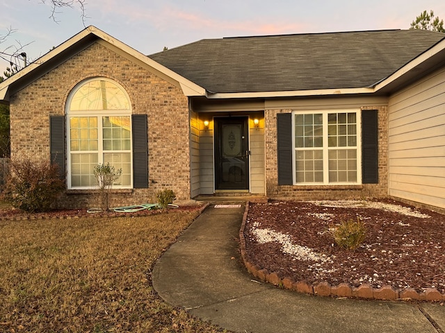 view of exterior entry at dusk