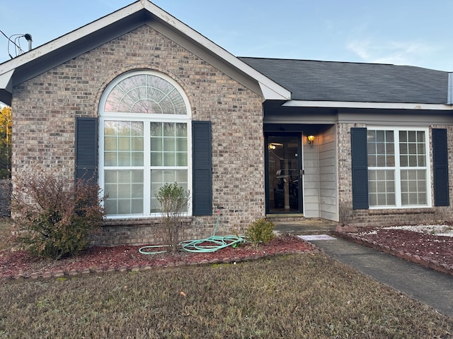 entrance to property with a yard