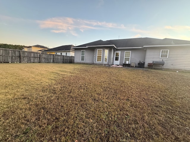 rear view of property with a yard