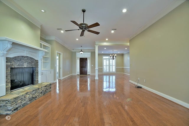 4701 Turnberry Ln Unit 6, Columbus, GA 31909 - unfurnished living room with hardwood / wood-style flooring, a stone fireplace, decorative columns, and ceiling fan with notable chandelier
