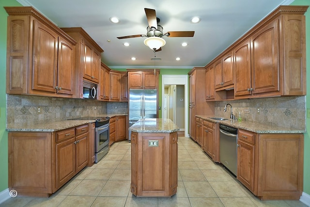 4701 Turnberry Ln Unit 6, Columbus, GA 31909 - kitchen featuring a kitchen island, sink, light stone counters, light tile patterned floors, and appliances with stainless steel finishes