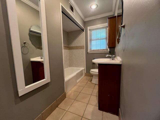 4154 Will Rhoades Dr, Columbus, GA 31909 - full bathroom with crown molding, vanity, toilet, tile patterned floors, and shower / bathtub combination