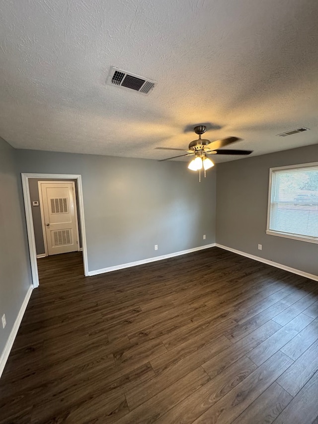 unfurnished room with a textured ceiling, ceiling fan, and dark hardwood / wood-style floors