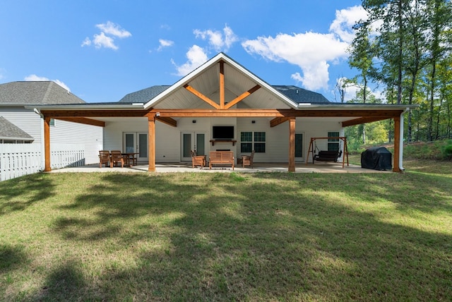 rear view of property featuring french doors, a yard, a patio, and ceiling fan