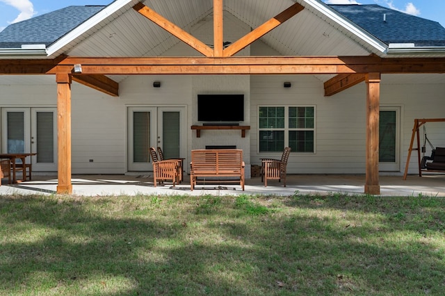 back of property featuring french doors, a patio, and a lawn