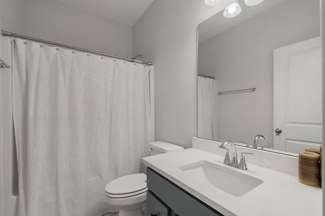 bathroom with vanity, toilet, and walk in shower