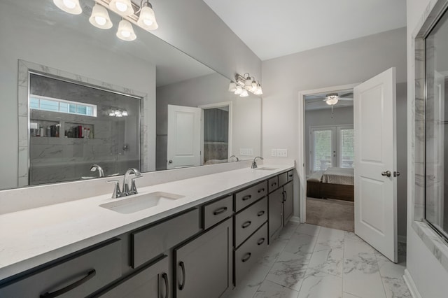 bathroom with a tile shower, ceiling fan, and vanity