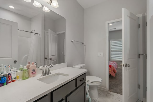 bathroom with vanity, toilet, and walk in shower