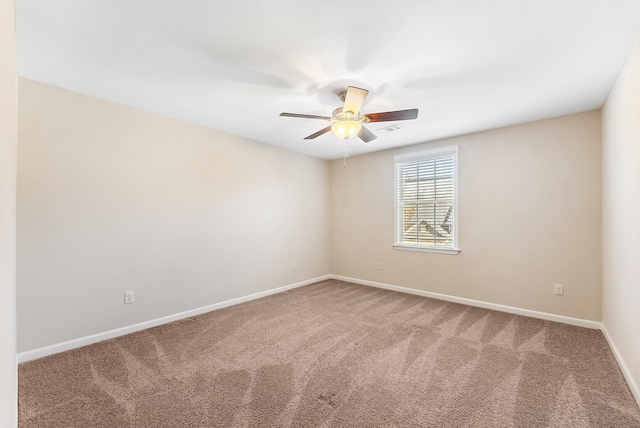 carpeted empty room featuring ceiling fan