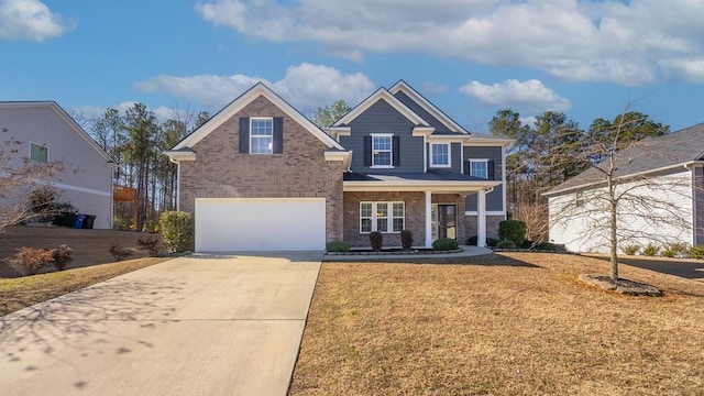 view of front of property with a garage, a front yard, and covered porch