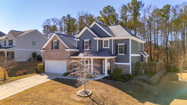 view of front property featuring a garage and a front yard