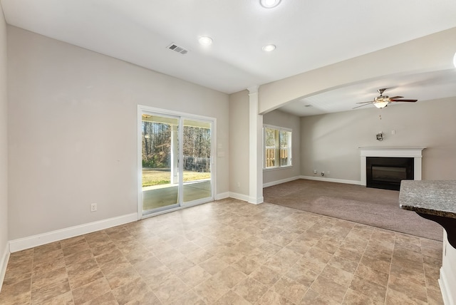 unfurnished living room featuring ceiling fan