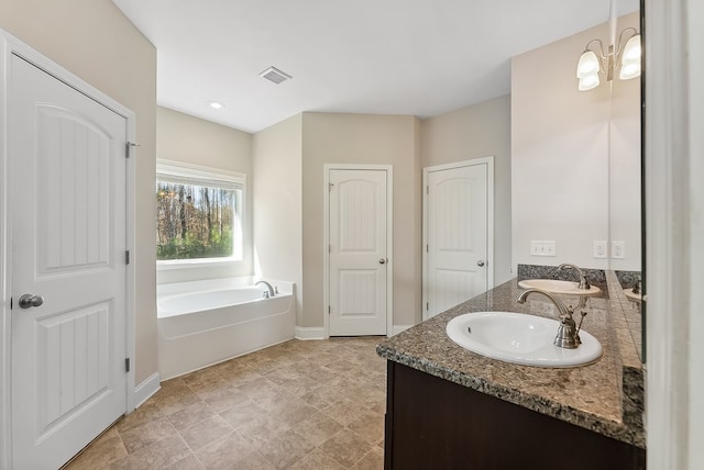 bathroom featuring vanity and a tub