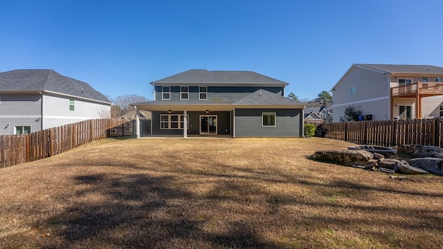 rear view of property with a lawn and a patio area