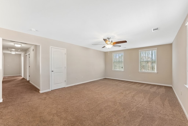 unfurnished room with ceiling fan and carpet