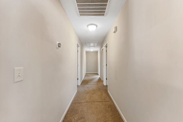 hallway featuring light colored carpet