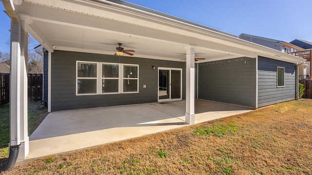 back of house featuring ceiling fan, a patio area, and a lawn